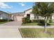 One-story house featuring a brick driveway and lush lawn at 2756 Greenlands St, St Cloud, FL 34772