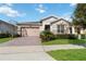 Single-story home with a two-car garage and landscaped yard at 2756 Greenlands St, St Cloud, FL 34772