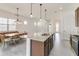 Modern kitchen with island, stainless steel appliances, and granite countertops at 2756 Greenlands St, St Cloud, FL 34772