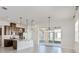 Open kitchen with island and view into the dining area at 2756 Greenlands St, St Cloud, FL 34772
