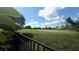 View of a grassy backyard beyond a black fence at 2835 Crane Trace Cir, Orlando, FL 32837