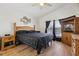 Comfortable main bedroom with wood floors and TV at 2835 Crane Trace Cir, Orlando, FL 32837