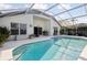 Inviting pool area with covered patio, grill, and lush landscaping at 2835 Crane Trace Cir, Orlando, FL 32837