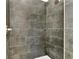 Large walk-in shower with dark gray tile at 285 N Kentucky Ave, Umatilla, FL 32784