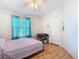 Bedroom with double bed, teal curtains, and wood-look flooring at 301 Evandee Ct, Kissimmee, FL 34758