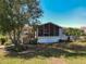 Charming single-story home featuring a screened-in porch and mature landscaping, perfect for enjoying the outdoors at 301 Evandee Ct, Kissimmee, FL 34758