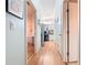 Light-filled hallway with light wood flooring, leading to kitchen and other rooms at 301 Evandee Ct, Kissimmee, FL 34758