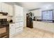 White cabinets, tile backsplash, and black appliances fill this kitchen at 301 Evandee Ct, Kissimmee, FL 34758