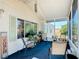 Relaxing screened porch with rocking chairs and potted plants at 301 Evandee Ct, Kissimmee, FL 34758