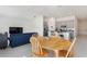 Bright dining room with wood table and chairs, open to the kitchen at 313 Loch Ct, Davenport, FL 33837