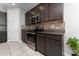 Kitchen with dark wood cabinets, stainless steel appliances, and tile backsplash at 3573 Bristol Cove Ln, St Cloud, FL 34772