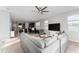 Open-concept living room with kitchen view, sectional sofa, and TV at 3573 Bristol Cove Ln, St Cloud, FL 34772