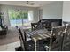 Living room with sliding glass doors, gray sofa, and ceiling fan at 3573 Bristol Cove Ln, Saint Cloud, FL 34772