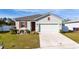 Charming home with well-maintained lawn, two-car garage, and seasonal decor by the front door at 3573 Bristol Cove Ln, St Cloud, FL 34772