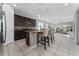 Modern kitchen with a center island, granite countertops, stainless steel appliances, and tile flooring at 3573 Bristol Cove Ln, St Cloud, FL 34772