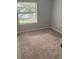 Spacious bedroom with large window and neutral carpeting at 3854 Southpointe Dr # 1, Orlando, FL 32822
