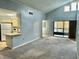 Living room with view into kitchen and access to balcony at 3854 Southpointe Dr # 1, Orlando, FL 32822