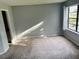 Spacious living room with carpeted floor and large window at 3854 Southpointe Dr # 1, Orlando, FL 32822