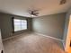 Spacious bedroom with carpeted floor, ceiling fan, and window coverings at 405 Briar Patch Loop, Davenport, FL 33896