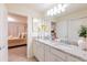 Bathroom with double vanity, granite countertop, and view of bedroom at 4154 Lana Ave, Davenport, FL 33897