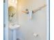 Small half bathroom with pedestal sink and unique decor at 4154 Lana Ave, Davenport, FL 33897