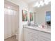 Double vanity bathroom with granite countertop and shower at 4154 Lana Ave, Davenport, FL 33897