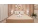 King-size bed in a calm bedroom with beige bedding and gold accents at 4154 Lana Ave, Davenport, FL 33897