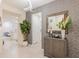 Stylish entryway with patterned wallpaper, console table, and mirror at 4154 Lana Ave, Davenport, FL 33897