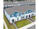 Two-story townhome with blue siding, gray roof and landscaped lawn at 4154 Lana Ave, Davenport, FL 33897