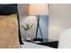 Nightstand with lamp and small plant decor at 4154 Lana Ave, Davenport, FL 33897