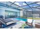 Screened-in pool area with lounge chairs and patio furniture at 4154 Lana Ave, Davenport, FL 33897
