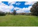 Large grassy backyard with mature trees and a privacy fence at 437 Seattle Slew Dr, Davenport, FL 33837