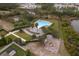Community pool with playground and surrounding landscaping at 437 Seattle Slew Dr, Davenport, FL 33837