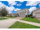 Two-story house with gray siding, brick driveway, and landscaped lawn at 437 Seattle Slew Dr, Davenport, FL 33837