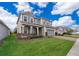 Two-story house with gray siding, brick driveway, and landscaped lawn at 437 Seattle Slew Dr, Davenport, FL 33837