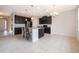 Spacious kitchen features an island, stainless steel appliances, and dark wood cabinets at 437 Seattle Slew Dr, Davenport, FL 33837