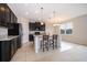 Modern kitchen with dark cabinets, granite counters and island at 437 Seattle Slew Dr, Davenport, FL 33837