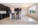 Modern kitchen with dark cabinets, granite counters and island at 437 Seattle Slew Dr, Davenport, FL 33837