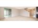 Open living area with neutral colors and access to a private patio at 437 Seattle Slew Dr, Davenport, FL 33837