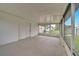 Empty screened porch with concrete floor and backyard view at 4401 Marshall St, Orlando, FL 32811