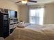 Bright bedroom with a queen bed and built-in shelving at 5275 Images Cir # 204, Kissimmee, FL 34746