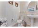 Small half bathroom with pedestal sink and toilet at 7211 Still Pond Ln, Windermere, FL 34786