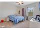Charming bedroom with a double bed and window at 7211 Still Pond Ln, Windermere, FL 34786
