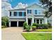 Two-story home with gray siding, two-car garage, and landscaped front yard at 7211 Still Pond Ln, Windermere, FL 34786