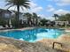 Community pool with lounge chairs and patio area at 7211 Still Pond Ln, Windermere, FL 34786