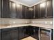 Modern wet bar with dark cabinetry and a beverage cooler at 8358 Lookout Pointe Dr, Windermere, FL 34786