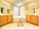 Bright bathroom showcasing a large garden tub, dual sinks, and decorative light fixtures at 8557 La Isla Dr, Kissimmee, FL 34747