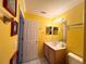 Clean bathroom with yellow walls and a vanity at 8557 La Isla Dr, Kissimmee, FL 34747