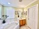 Bathroom with corner tub and single vanity at 8557 La Isla Dr, Kissimmee, FL 34747