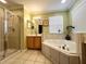 Bathroom with corner tub and walk-in shower at 8557 La Isla Dr, Kissimmee, FL 34747
